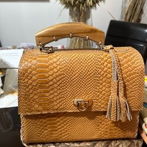 Handcraft purse with wood, and leather tan color.